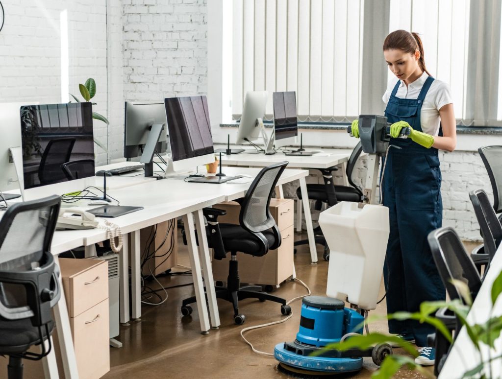 young cleaner washing floor in open space office